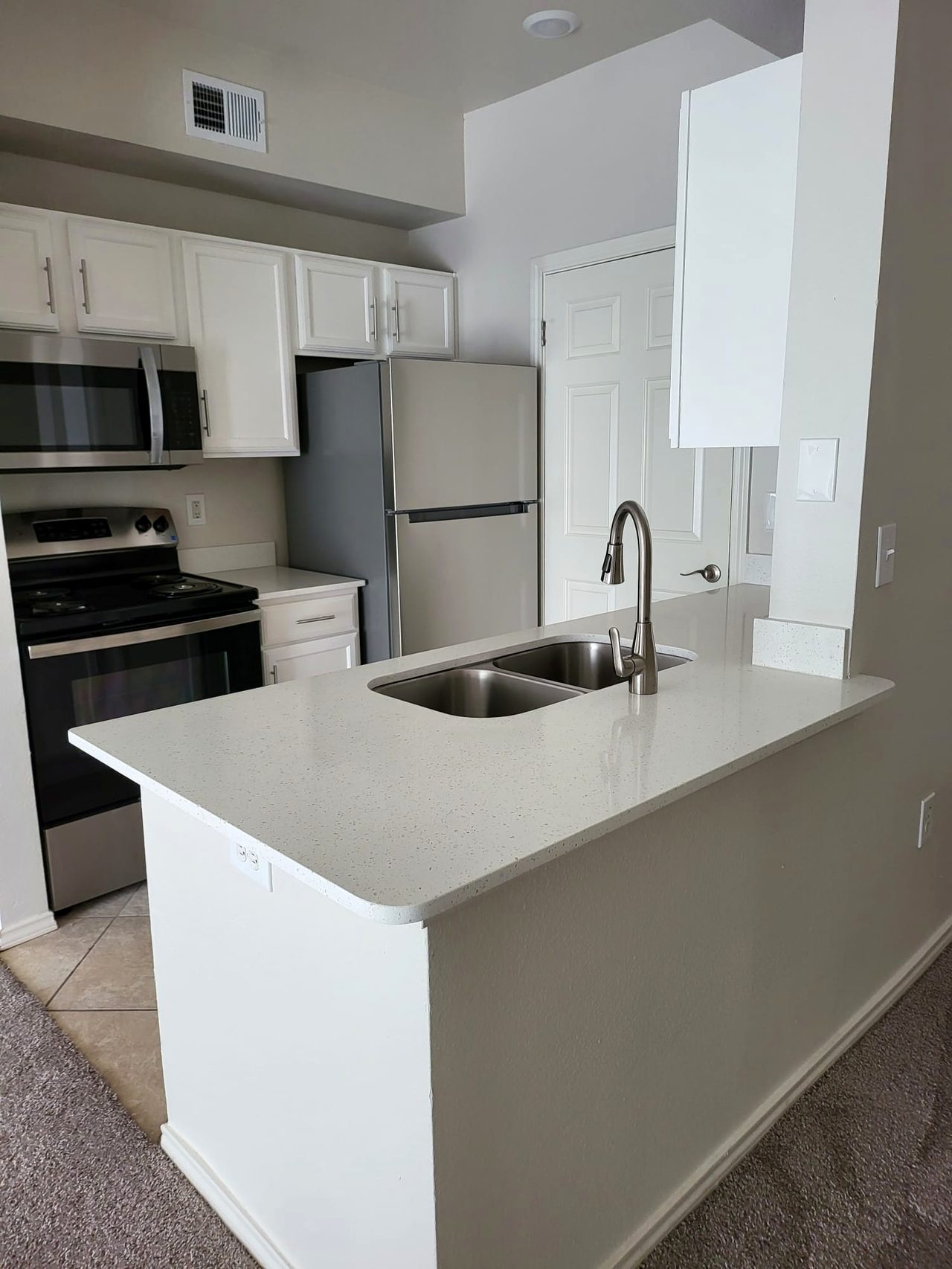 Custom white bathroom vanity with quartz top and large mirror