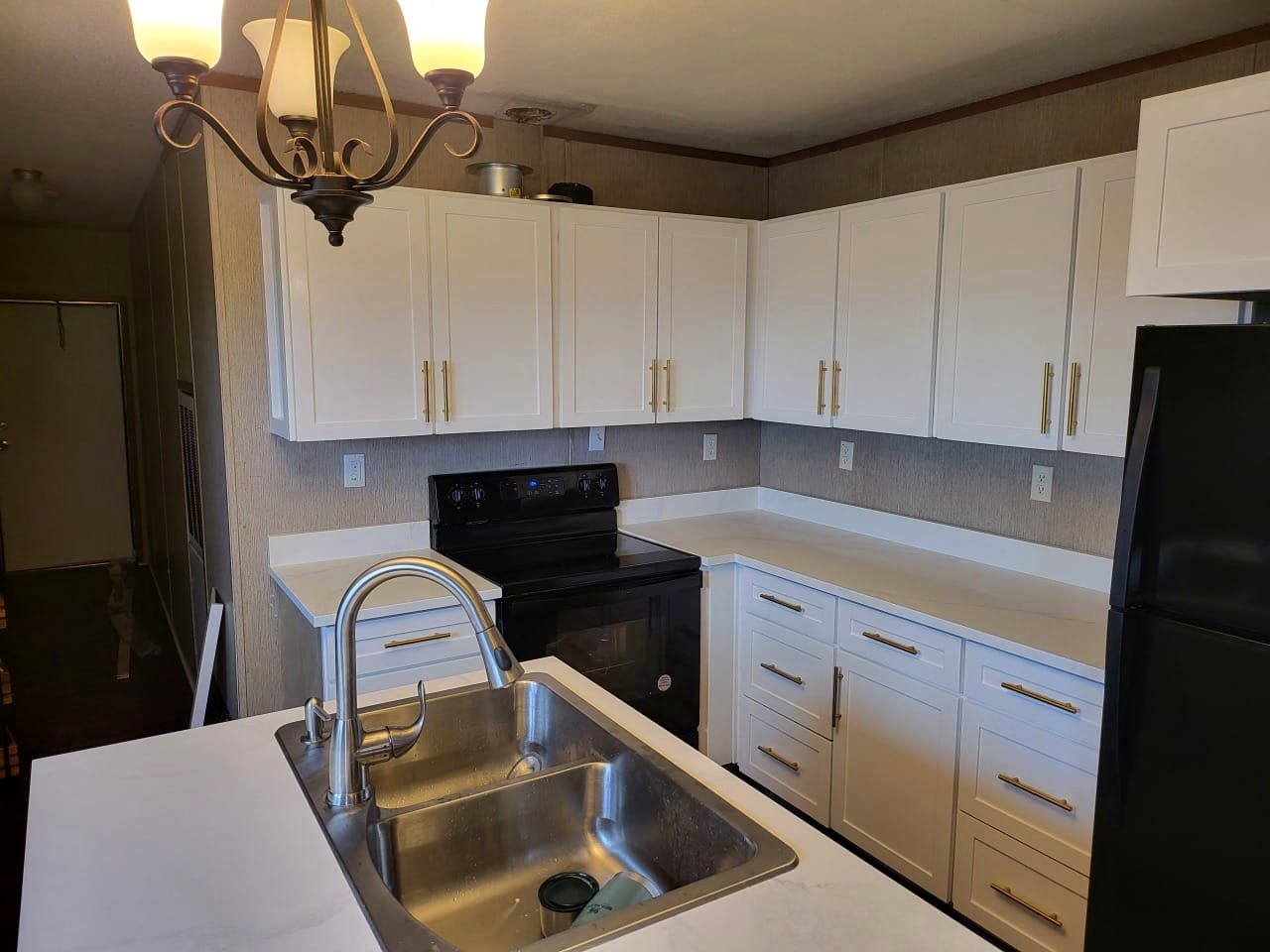 White shaker kitchen with brass hardware throughout