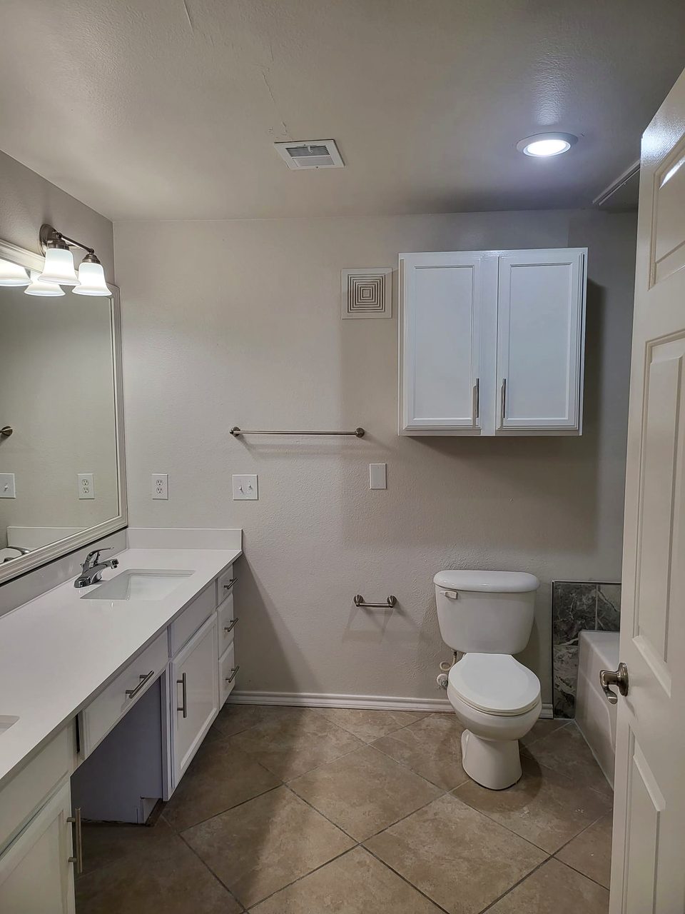 Bathroom with white vanity and quartz top