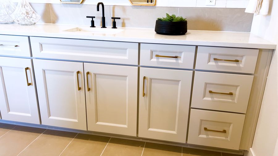 Bathroom vanity with white countertop and black fixtures